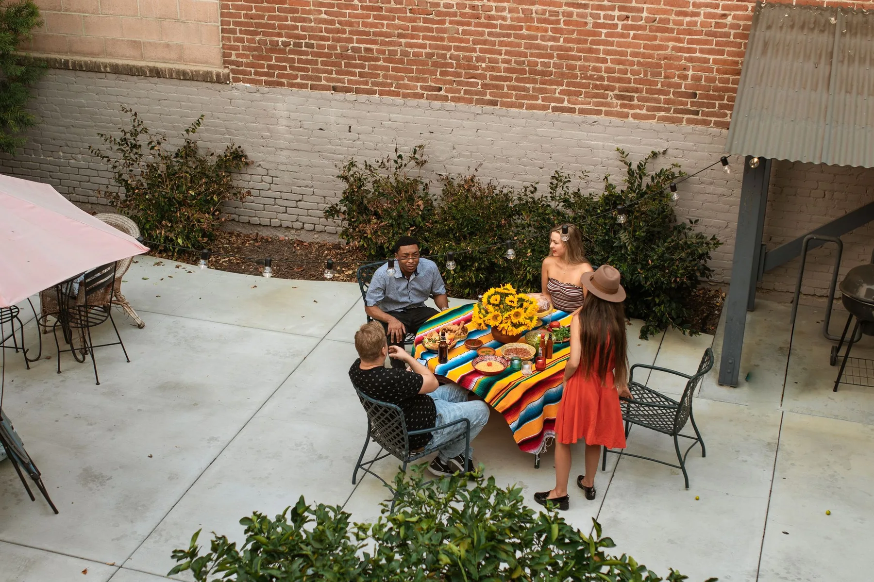 Friends enjoying lunch in a leafy courtyard