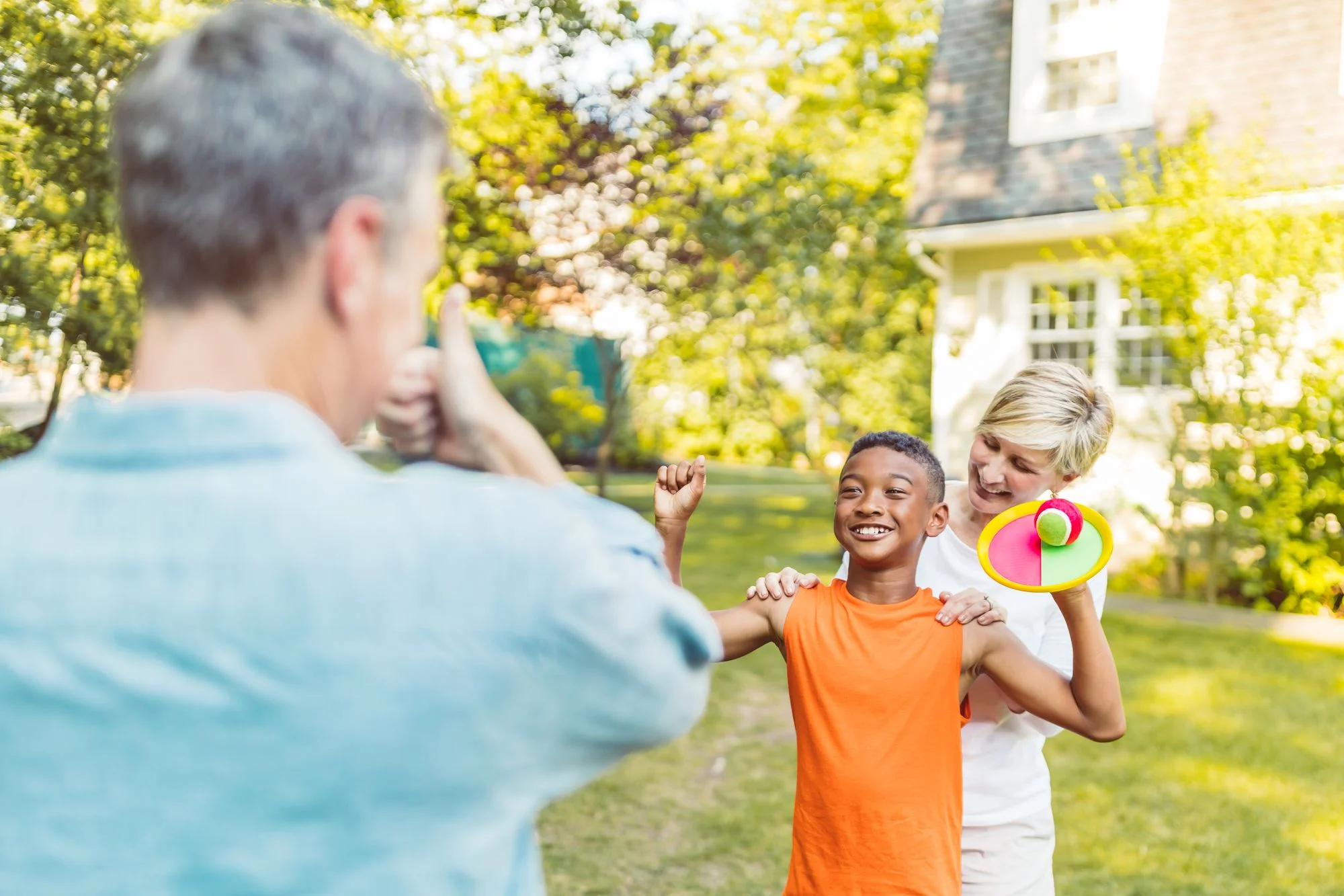 A family enjoying an afternoon of play in their backyard
